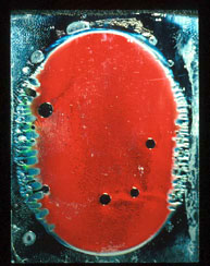 A drop of 55 wt.% HPC in water,  sandwiched between microscope slides and viewed in white light against a black background  showed a red reflected colour.